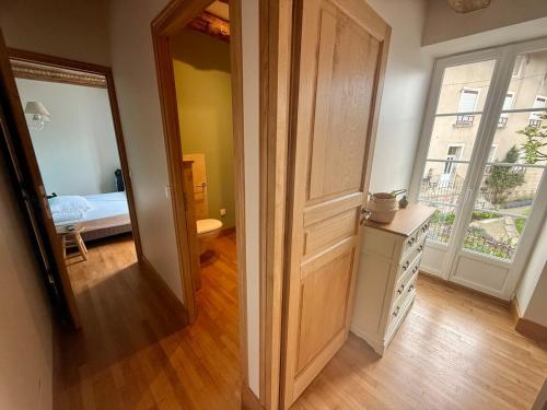 a room with a door leading to a bedroom at Gîte de la porcelaine, 4 pers in Giey-sur-Aujon