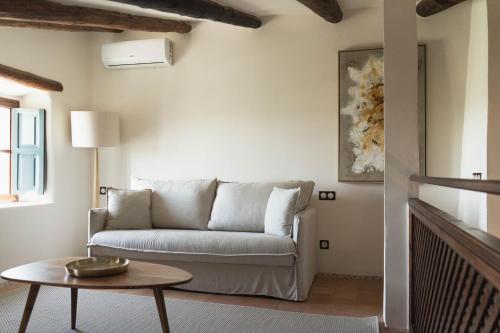 a living room with a couch and a table at Reserva Rotana Golf Resort in Manacor
