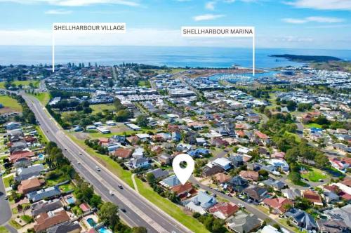 an aerial view of a suburb with houses and a highway at Hilltop Haven - Shell Cove in Shellharbour