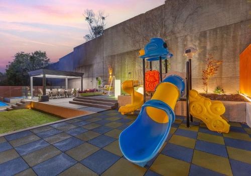 a playground with a blue and yellow slide at The Great Escape at Shell Cove in Dunmore