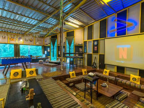 a large room with a pool table and a board at The Hosteller Kasol in Kasol