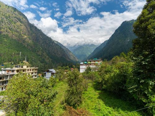 a view of a valley with mountains in the background at The Hosteller Kasol in Kasol