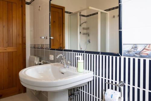 a bathroom with a white sink and a mirror at Villa Bonaccia - YourPlace Abruzzo in Ortona
