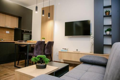 a living room with a couch and a table at POOL RESORT- Vila Lena- Apartman 2 in Vrdnik