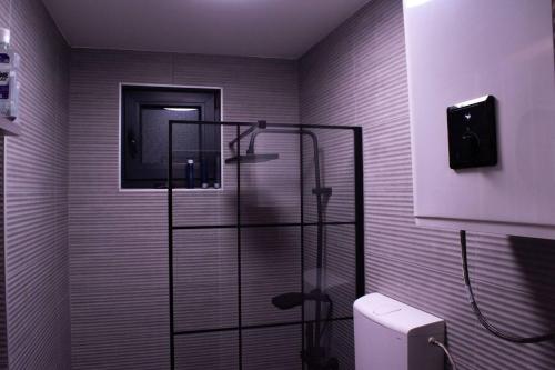 a bathroom with a glass shower with a toilet at Funky House Sarajevo in Ilovice