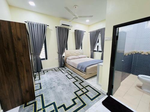 a bedroom with a bed and a shower and a bathroom at Tokwan Homestay, Alor Setar Kedah in Alor Setar