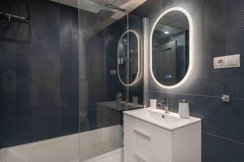 a bathroom with a sink and a mirror at Sunny apartment with balcony & swimming pool by REMS in Sitio de Calahonda