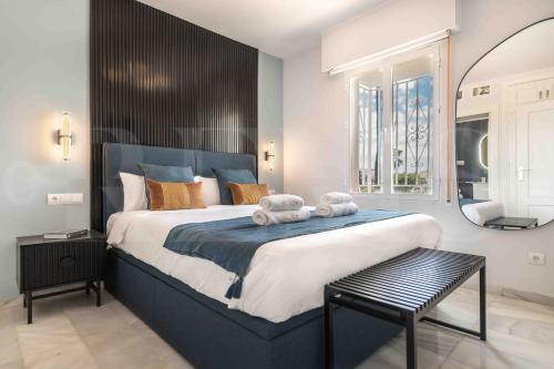 a bedroom with a large bed with two teddy bears on it at Sunny apartment with balcony & swimming pool by REMS in Sitio de Calahonda