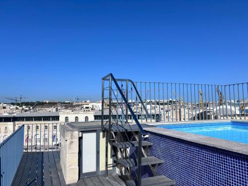 a staircase on top of a building with a swimming pool at Casa Birmula Boutique Hotel in Cospicua