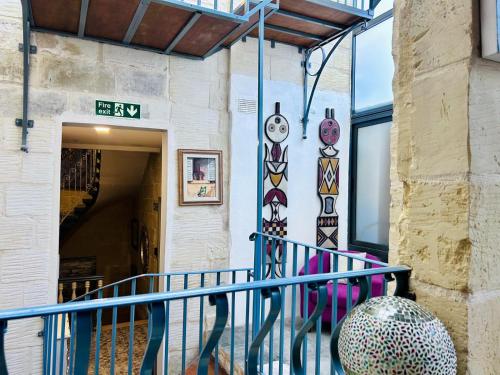 a staircase in a building with a mural on the wall at Casa Birmula Boutique Hotel in Cospicua