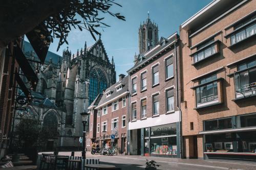a city street with buildings and a cathedral at Anne&Max Boutique Hotel in Utrecht