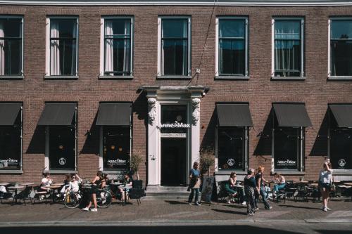 a group of people standing outside of a brick building at Anne&Max Boutique Hotel in Utrecht