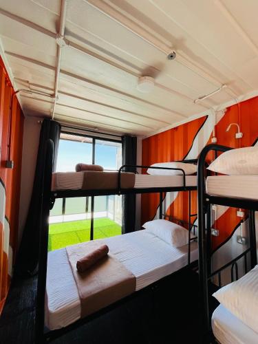 a group of bunk beds in a room with a window at Perhentian Nemo Chalet in Perhentian Island