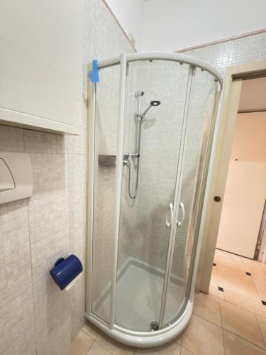 a shower with a glass door in a bathroom at Riva dei fiori in Viareggio