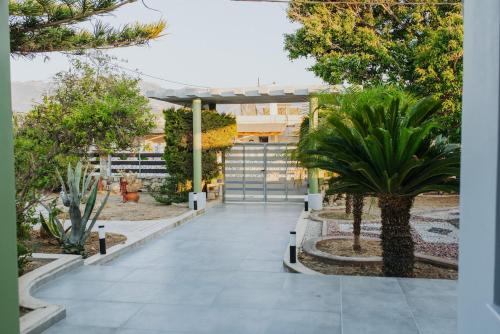 a courtyard with trees and plants in a building at Relax Villa in Marmari