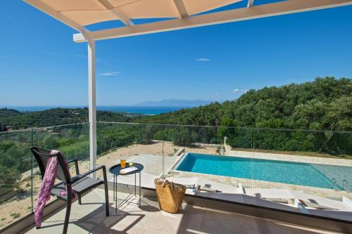 a view from the balcony of a villa with a swimming pool at Villa Sunset, stunning villa rental in Corfu by PosarelliVillas in Perítheia