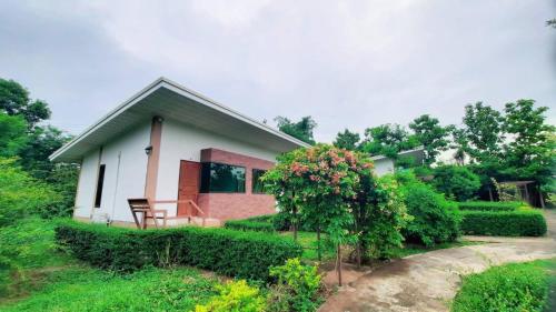 a house with a table and a chair in front of it at Ina Boutique Home Nan in Nan