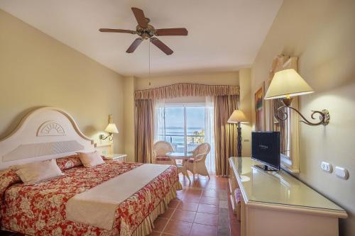 a hotel room with a bed and a television at Eurostars Grand Cayacoa in Santa Bárbara de Samaná