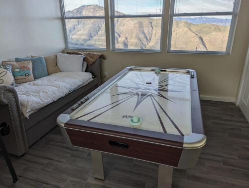 a living room with a foosball table in front of a couch at Unique Mountain Gem-Sauna Hot Tub Scenic View in Julian