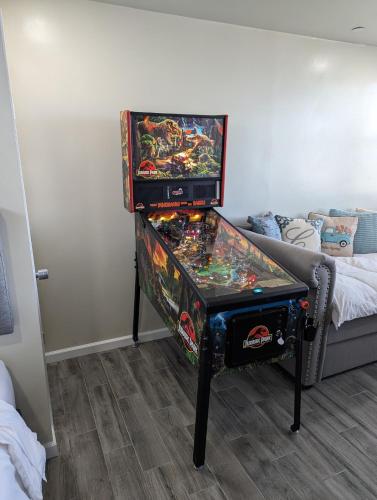a pinball machine in a room with a couch at Unique Mountain Gem-Sauna Hot Tub Scenic View in Julian