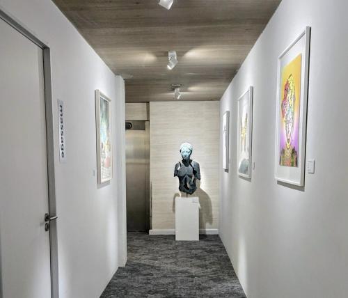 a museum hallway with a statue on a pedestal at South Beach Camps Bay Boutique Hotel in Cape Town