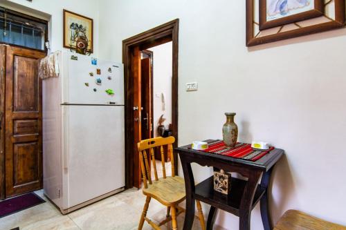 a kitchen with a table and a refrigerator at BREAD HOUSE in Bethlehem