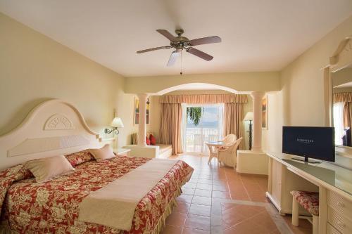 a hotel room with a bed and a television at Eurostars Grand Cayacoa in Santa Bárbara de Samaná