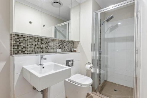 a bathroom with a sink and a toilet and a shower at Yaran Suites in Rockingham