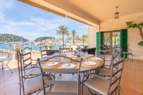 a table on a balcony with a view of the water at Sa Caleta in Port de Soller