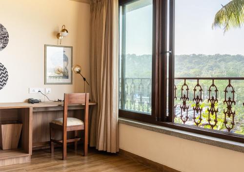 an office with a desk and a window with a view at Casa Peacock in Calangute