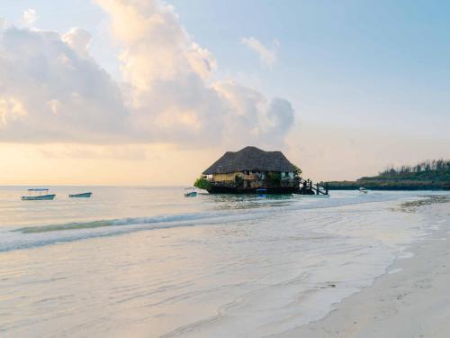 a shack on the beach in the water at Shanuo Beach Bungalows in Michamvi