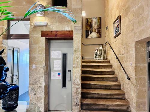 a staircase leading up to a door in a building at Casa Birmula Boutique Hotel in Cospicua