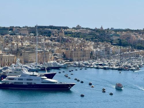 a large boat is docked in a harbor at Casa Birmula Boutique Hotel in Cospicua