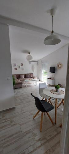 una sala de estar con una mesa y un sofá en Apartmani.Sutomore, en Sutomore