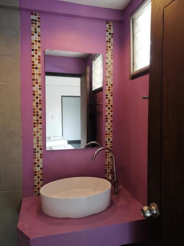 a bathroom with a large mirror and a sink at บ้านสันติ in Chiang Rai