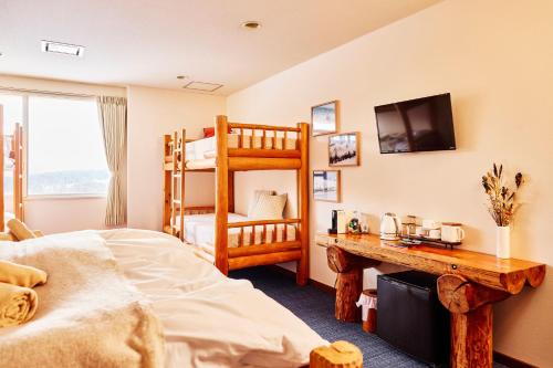 Postel nebo postele na pokoji v ubytování Canopy Lodge - Boutique Lodge at Hakuba Cortina