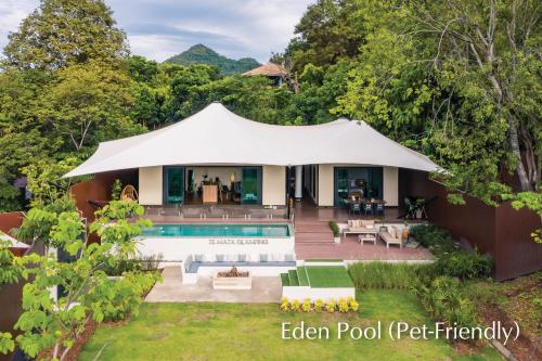 a house with a swimming pool in a yard at Te Mata Glamping in Nong Nam Daeng
