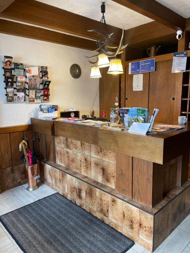 a bar in a restaurant with a counter at Landhotel Jägerhof in Bischofsgrün