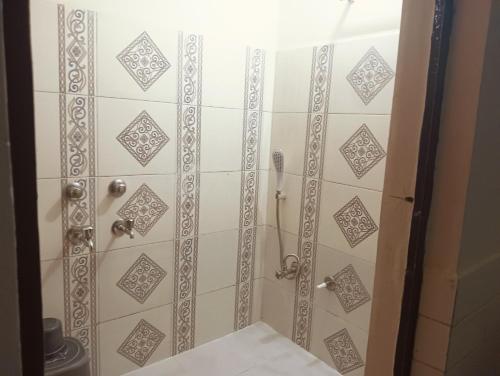 a bathroom with a shower with a shower curtain at Shiv Homestay in Lucknow