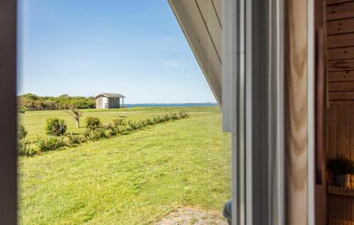 a window view of a field with a house in the distance at Nice Home In Vinderup With Kitchen in Vinderup