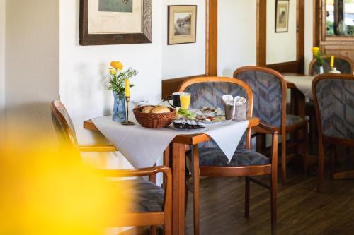 a dining room table with a white table cloth and chairs at Zur Rennbahn in Drage