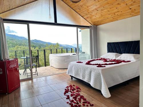 a bedroom with a tub and a bed with flowers on the floor at Divino Glamping Romantico Jacuzzi Villeta NUEVO in Villeta