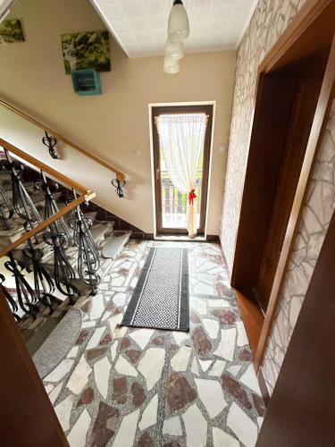 a hallway with a door leading to a window at Agroturystyka Górski Wypoczynek in Stryszawa