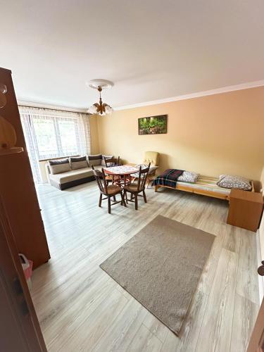 a living room with a table and a couch at Agroturystyka Górski Wypoczynek in Stryszawa