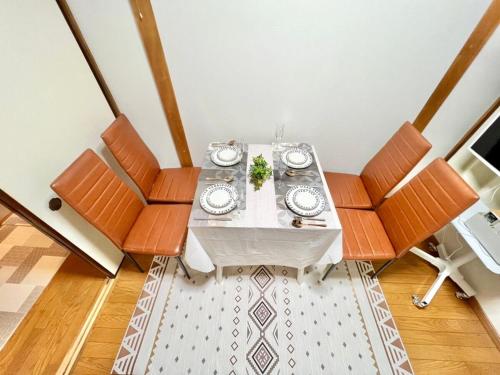 a dining room with a table and some chairs at Direct to Akihabara Shinjuku Max 6 people in Tokyo