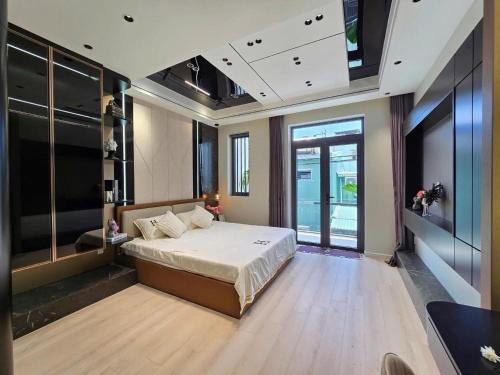 a large bedroom with a bed and a large window at Chani Home in Da Nang