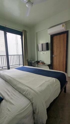 a bedroom with a large bed with a large window at MAHA RAAS A unit of RAAS LEELA Hotels and Resort in Udaipur