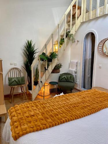 a bedroom with a bed and a staircase with plants at Villa provençale Golfe St Tropez climatisée piscine chauffée, Spa, billard, Wifi haut débit pro in Gassin