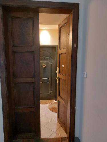 an open door leading to a room with a closet at YNH Mono SanCarlo Egyptian Museum Piazza San Carlo in Turin