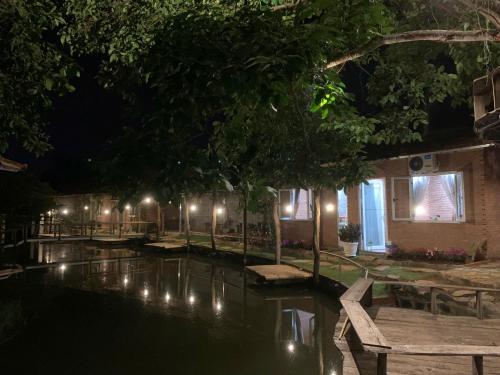 a pool at night with benches and lights at Suối Xanh Garden in Gia Nghĩa
